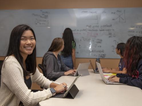 Image of students in a classroom sitting at a table